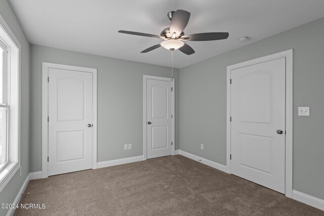 unfurnished bedroom featuring carpet flooring and ceiling fan