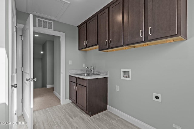 laundry area with cabinets, washer hookup, hookup for an electric dryer, and sink