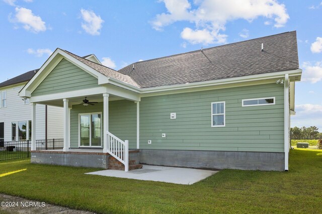 back of house with a yard and ceiling fan