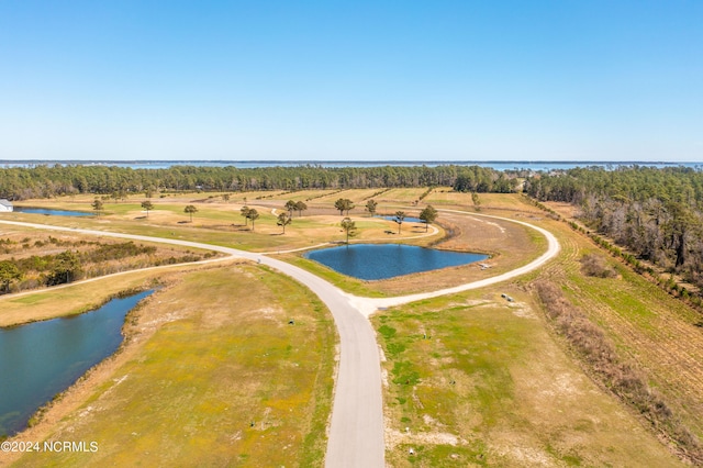 birds eye view of property featuring a water view and a rural view