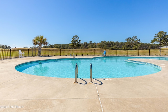 view of swimming pool featuring a patio area