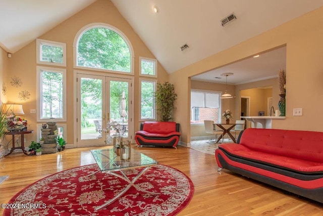 living room with a wealth of natural light, visible vents, and wood finished floors