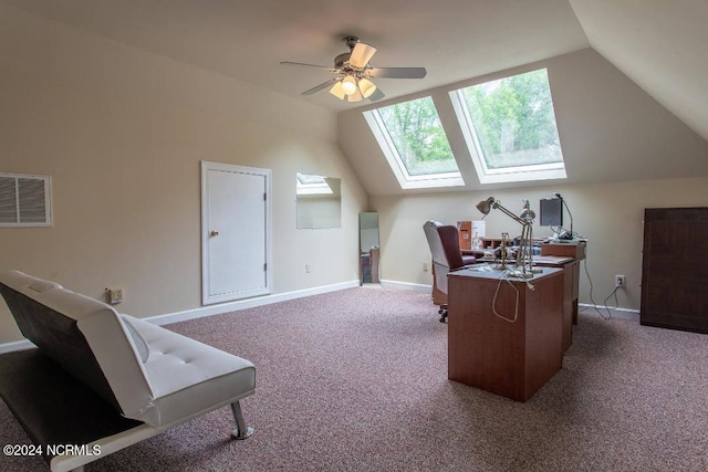 carpeted office with vaulted ceiling with skylight, visible vents, ceiling fan, and baseboards