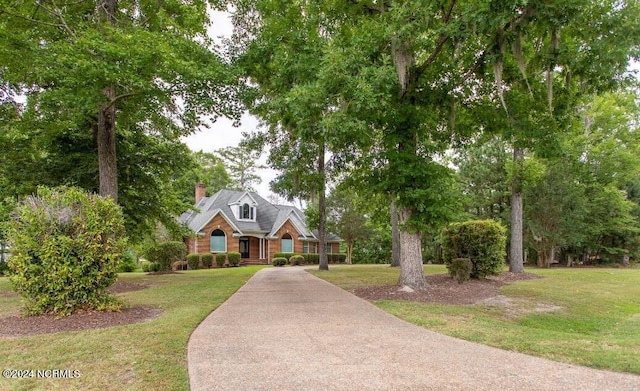 view of front of house with a front yard and a chimney