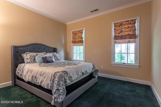 carpeted bedroom featuring baseboards, multiple windows, visible vents, and crown molding