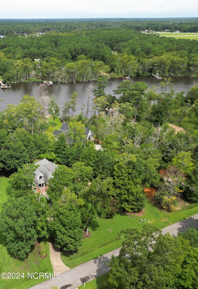 drone / aerial view with a water view and a wooded view