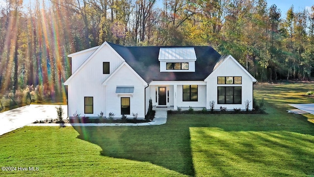 modern inspired farmhouse featuring a front lawn