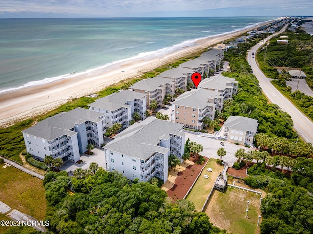 drone / aerial view with a water view and a beach view