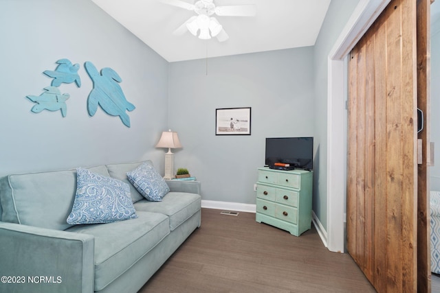 living room with hardwood / wood-style floors and ceiling fan