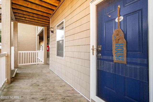 view of exterior entry with a porch