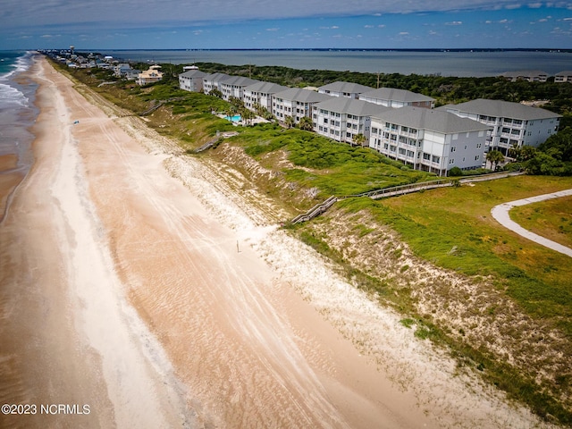 birds eye view of property featuring a water view and a view of the beach