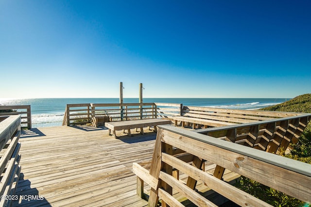 dock area featuring a water view and a view of the beach