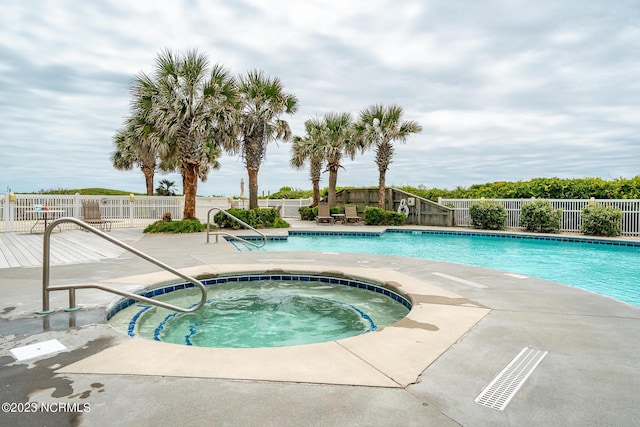 view of pool featuring an in ground hot tub and a patio area