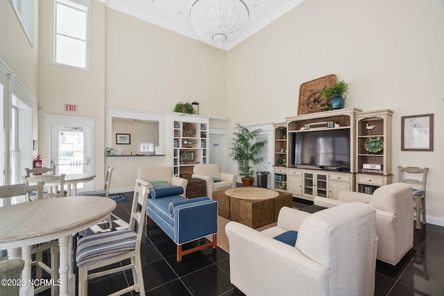 tiled living room with a notable chandelier, ornamental molding, and a high ceiling