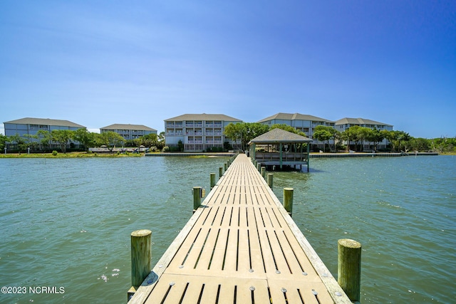 view of dock featuring a gazebo and a water view