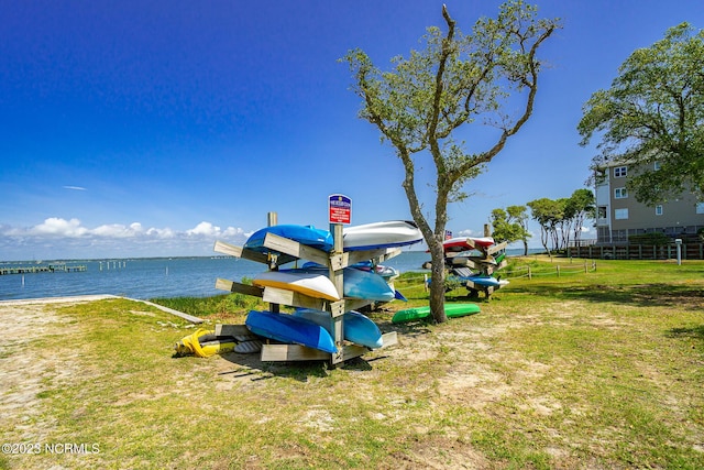 view of play area with a water view and a yard