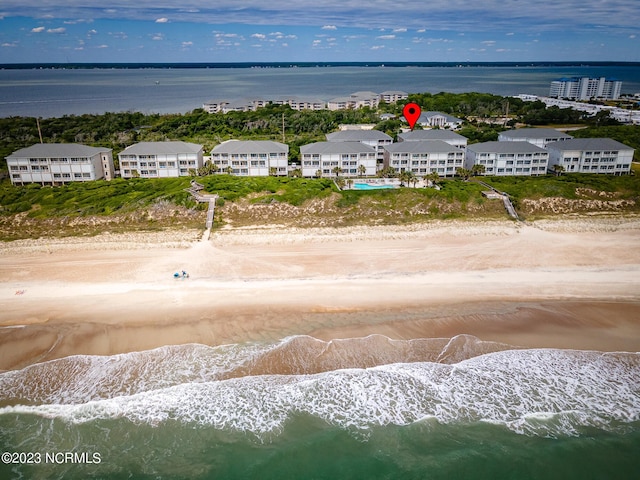 drone / aerial view with a water view and a beach view