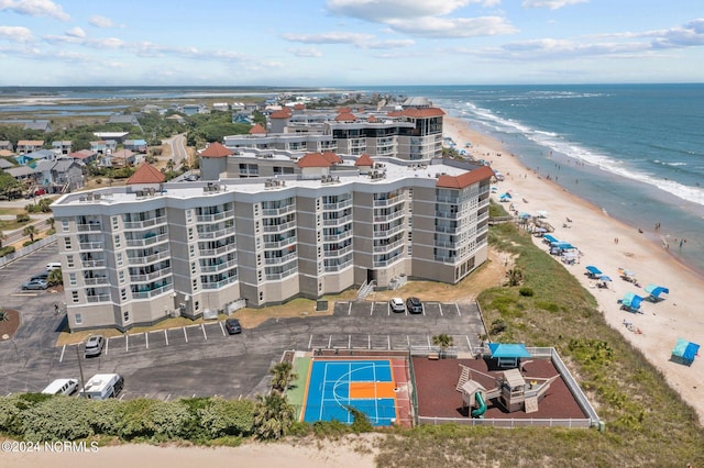 birds eye view of property featuring a view of the beach and a water view