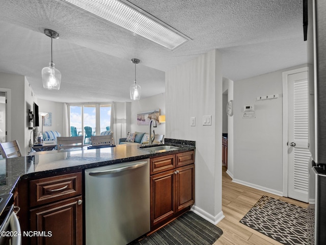 kitchen featuring light hardwood / wood-style floors, dishwasher, pendant lighting, and sink