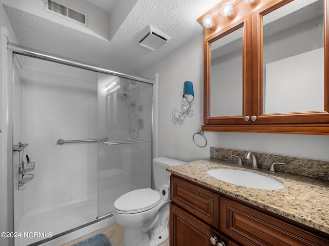 bathroom with tile patterned flooring, toilet, an enclosed shower, and a textured ceiling