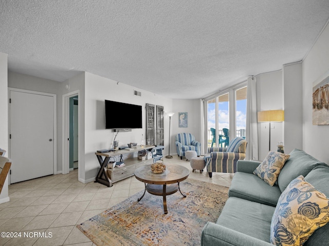 tiled living room featuring a textured ceiling