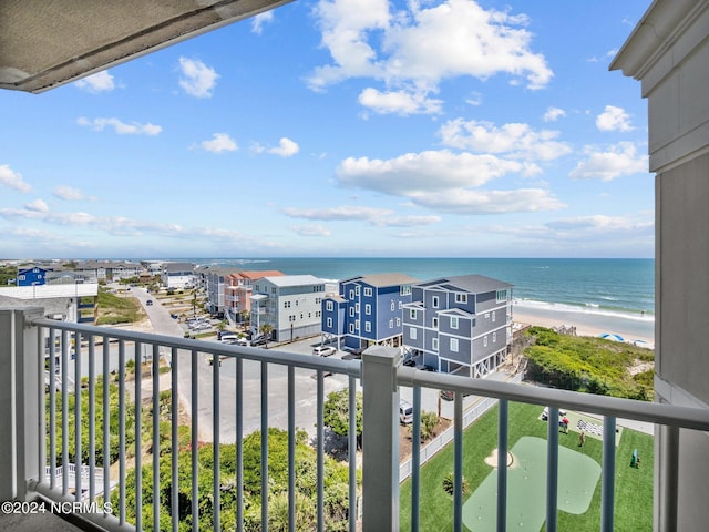 balcony featuring a water view and a view of the beach