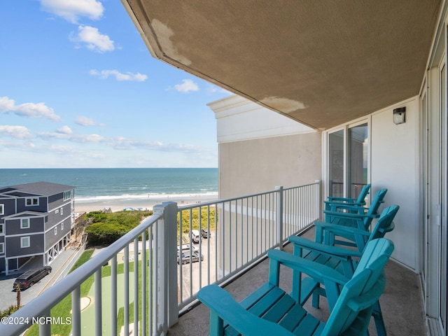 balcony with a beach view and a water view