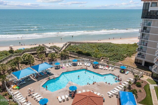 birds eye view of property featuring a water view and a view of the beach