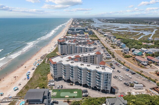 bird's eye view with a water view and a beach view