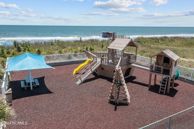 view of play area with a water view and a view of the beach