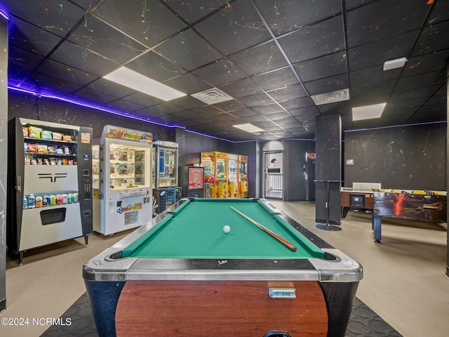 rec room featuring a paneled ceiling, concrete flooring, and billiards