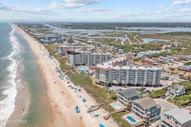 bird's eye view with a water view and a beach view