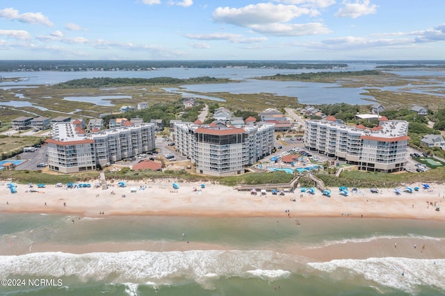 drone / aerial view featuring a water view and a view of the beach