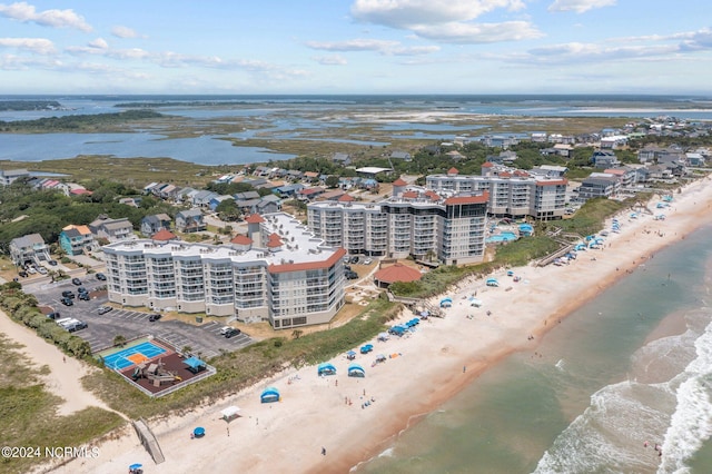 drone / aerial view with a water view and a view of the beach