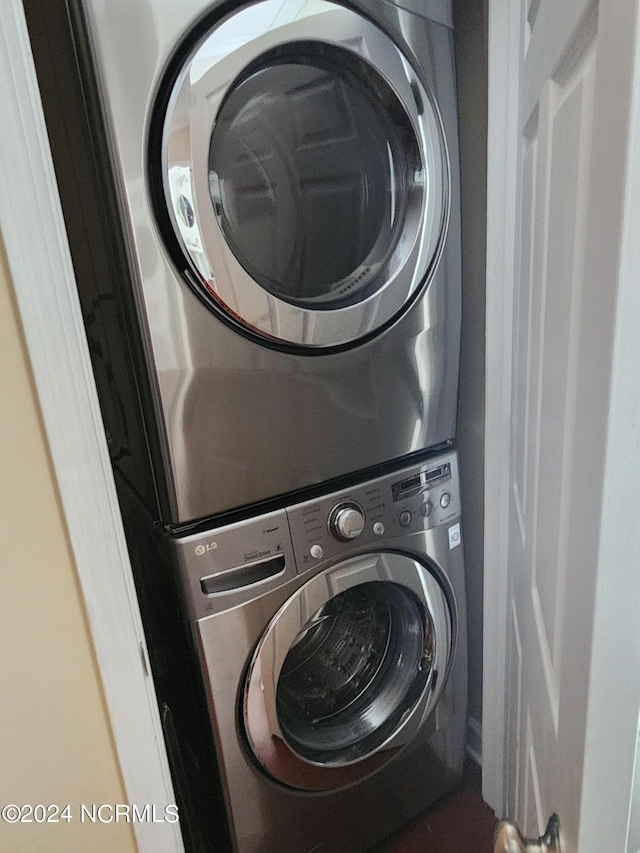 laundry area featuring stacked washer / drying machine