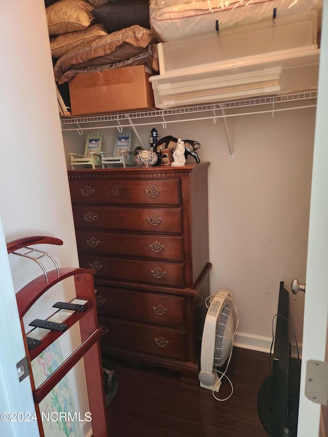 walk in closet with wood finished floors