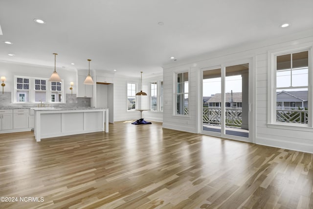 unfurnished living room featuring recessed lighting and light wood finished floors