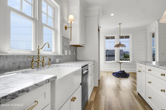 kitchen with decorative backsplash, dishwasher, wood finished floors, and white cabinetry