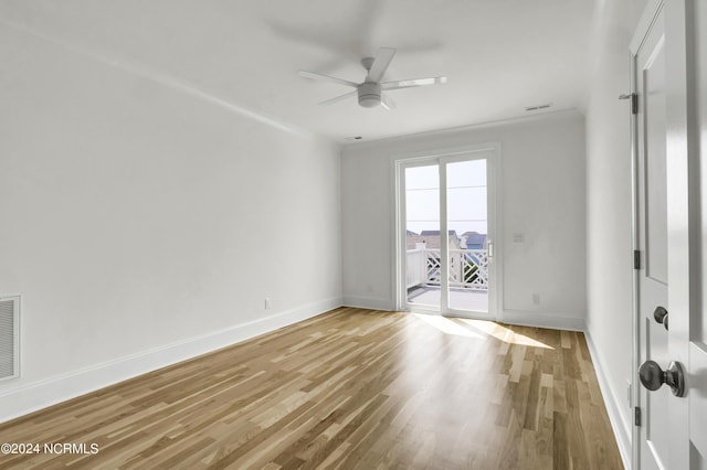 empty room with a ceiling fan, baseboards, visible vents, crown molding, and light wood-type flooring