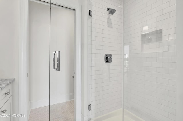 full bathroom featuring tile patterned floors and a shower stall