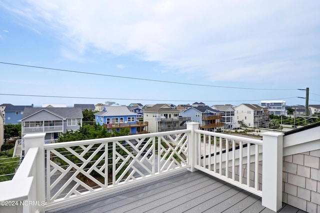 wooden terrace featuring a residential view