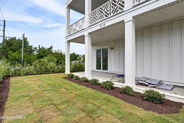 view of yard featuring a balcony and fence