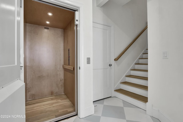 bathroom with elevator, recessed lighting, and tile patterned floors