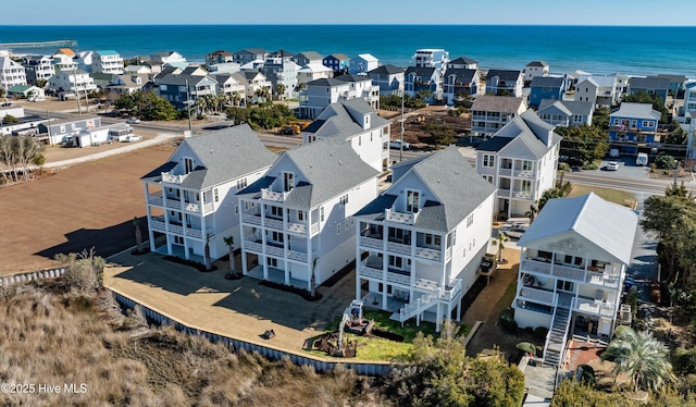 drone / aerial view featuring a water view and a residential view