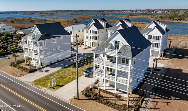 drone / aerial view with a water view and a residential view