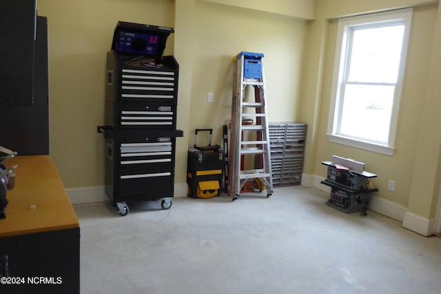 misc room featuring carpet and baseboards