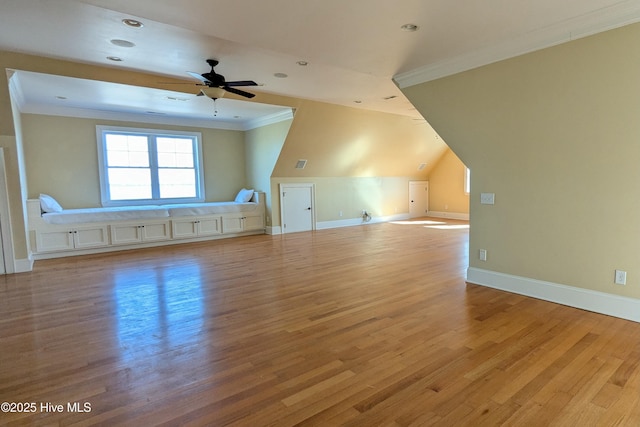 additional living space featuring light wood-style flooring, baseboards, and ceiling fan