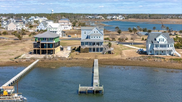 bird's eye view featuring a water view and a residential view