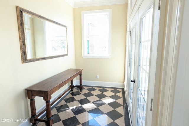 doorway with dark floors, baseboards, and crown molding