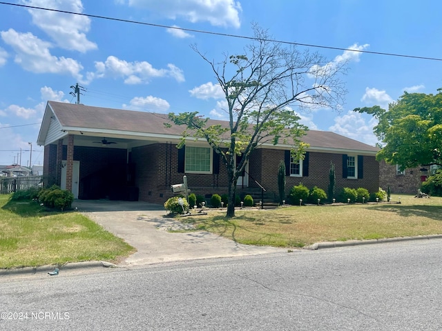 ranch-style house featuring a front yard and a carport